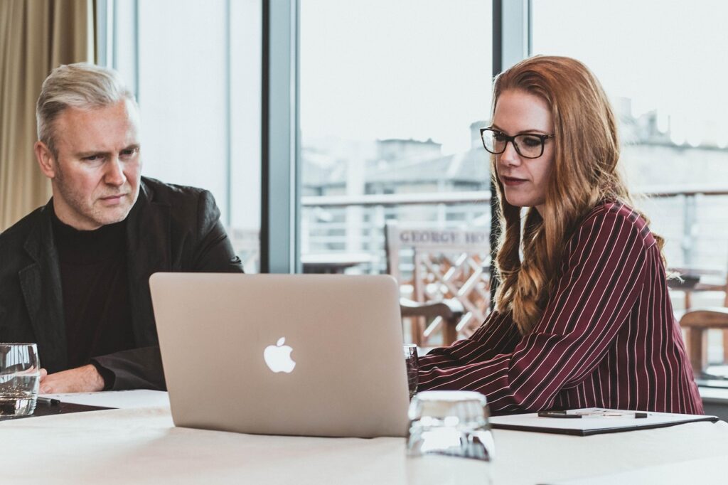 business man and business woman at computer with commercial office upgrade GTA